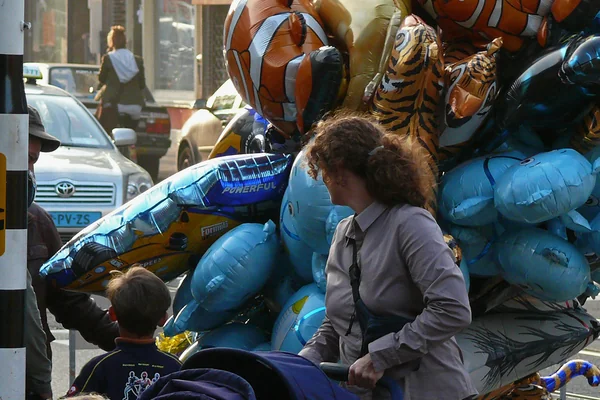 2008.10 - 'Balloon-party in the streets 6.', at the street-fair in the Kinkerstraat in the light of October; Amsterdam, district Oud-WestDutch photo - urban photography by Fons Heijnsbroek, The Netherlands