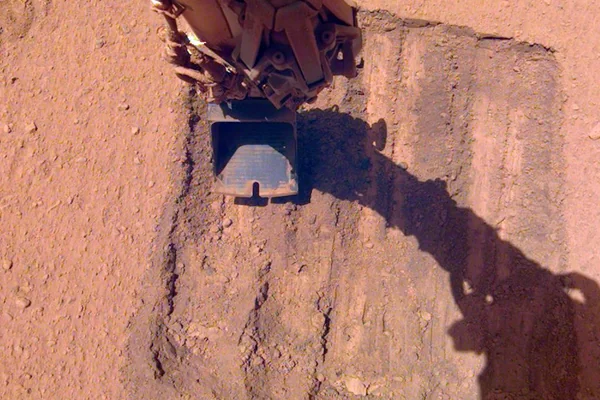 InSight's Robotic Arm Helps Remove Solar Panel Dust Trickles Sand in the Wind