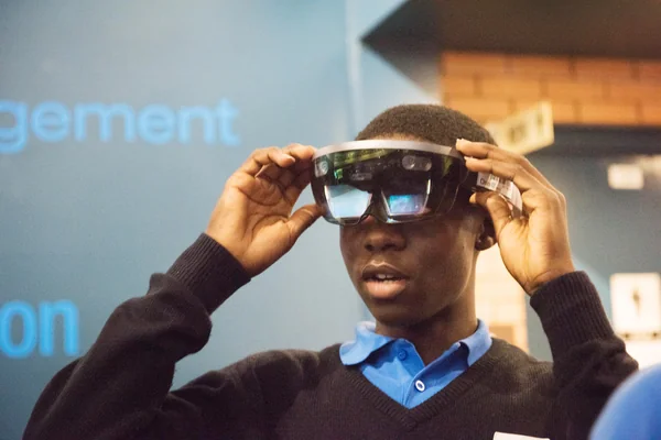 During Avaiation Day, 2018, a Participant uses a Microsoft HoloLens Virtual Reality Headset to view a NASA Created Immersive Visualization