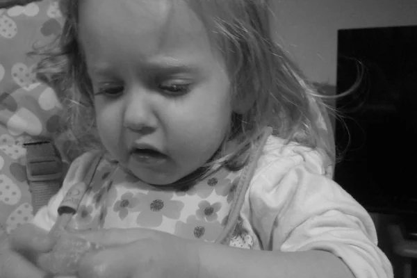 black & white portrait - evie eating some satsuma