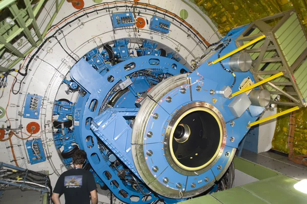A technician examines the instrument mounting structure and bulkhead of the German-built infrared telescope installed in NASA's SOFIA airborne observatory