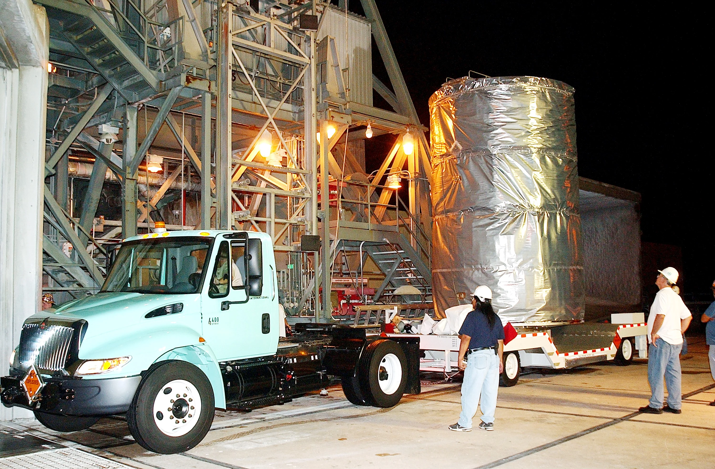 KENNEDY SPACE CENTER, FLA.  -  Before dawn, the Space Infrared Telescope Facility (SIRTF) arrives at Launch Pad 17-B, Cape Canaveral Air Force Station, where it will be lifted into the mobile service tower and prepared for launch.  SIRTF consists of three cryogenically cooled science instruments and an 0.85-meter telescope, and is one of NASA’s largest infrared telescopes to be launched.  It is the fourth and final element in NASA’s family of orbiting “Great Observatories.”  SIRTF will obtain images and spectra by detecting the infrared energy, or heat, radiated by objects in space. Most of this infrared radiation is blocked by the Earth's atmosphere and cannot be observed from the ground.