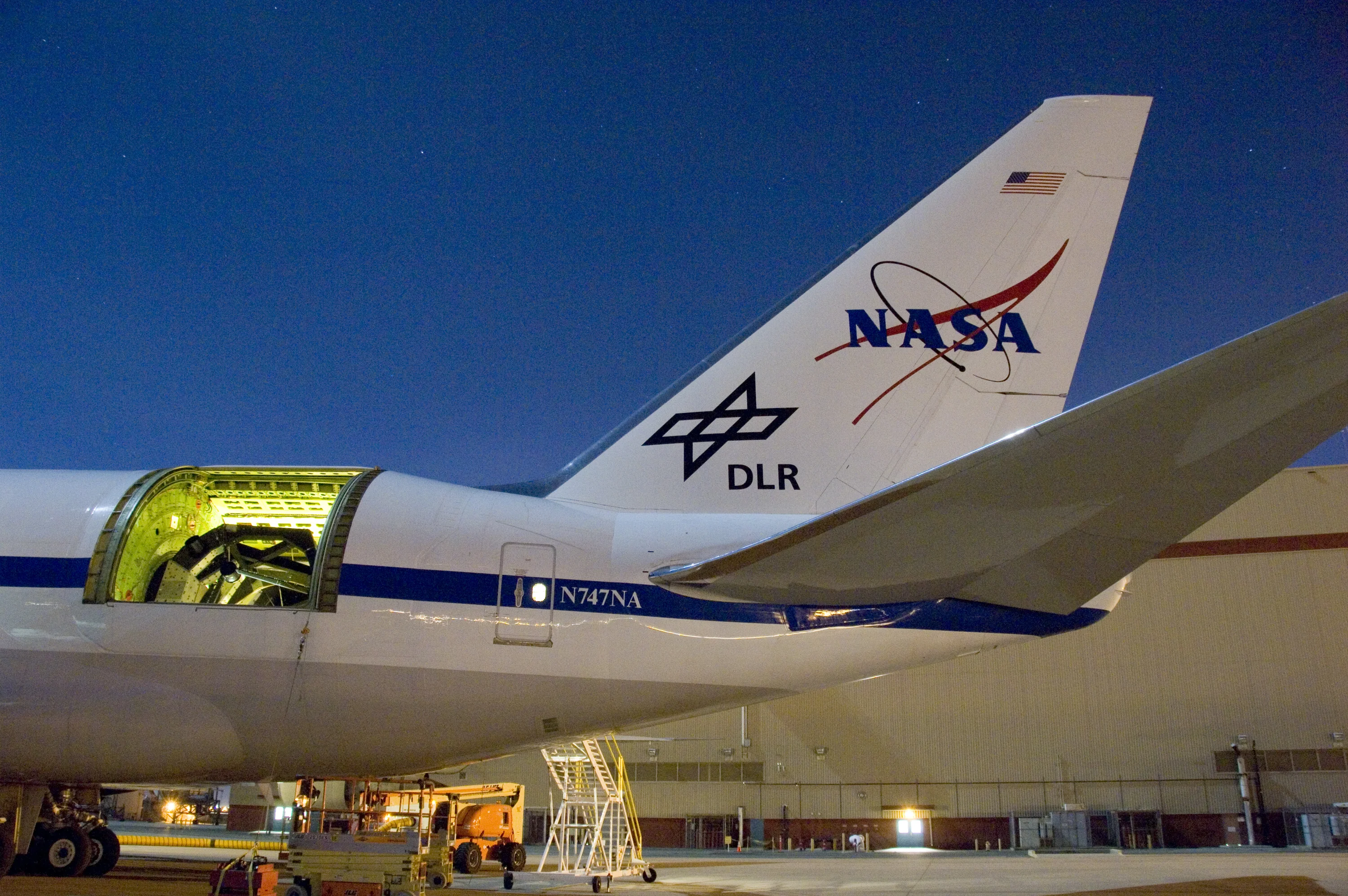 The SOFIA airborne observatory's 2.5-meter infrared telescope peers out from its cavity in the SOFIA rear fuselage during nighttime line operations testing