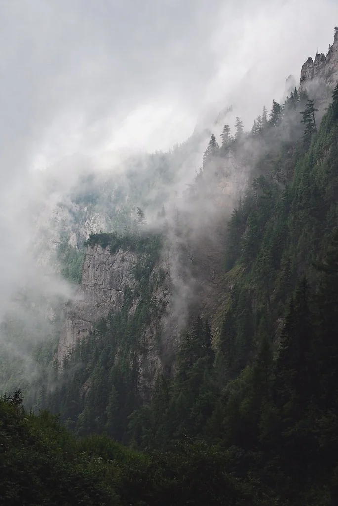 Barren rocky peaks covered by white fog